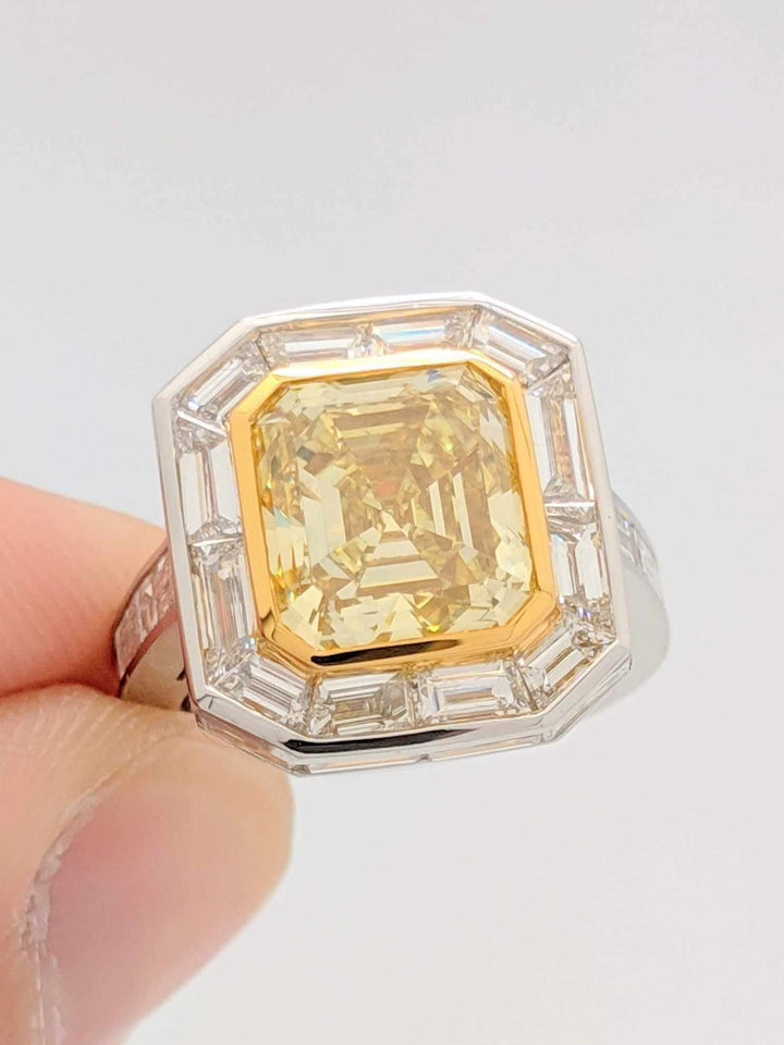 GIA Certified 5.01CT Emerald Cut Fancy Yellow Diamond Center Stone with Baguette Cut Diamond Halo Engagement Ring in Platinum