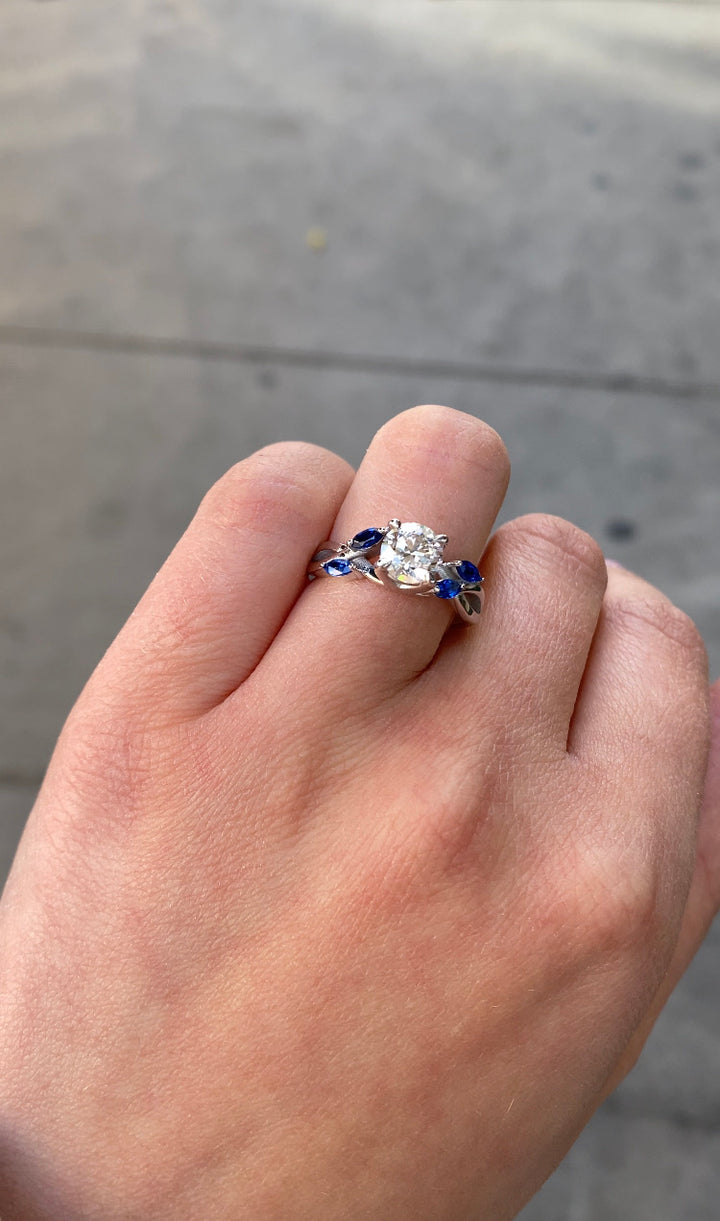 Sfera (2.85CT T.W.) - Round Cut Diamond Engagement Ring with Blue Sapphire Marquise Shape Sidestones - Gem Jewelers Co