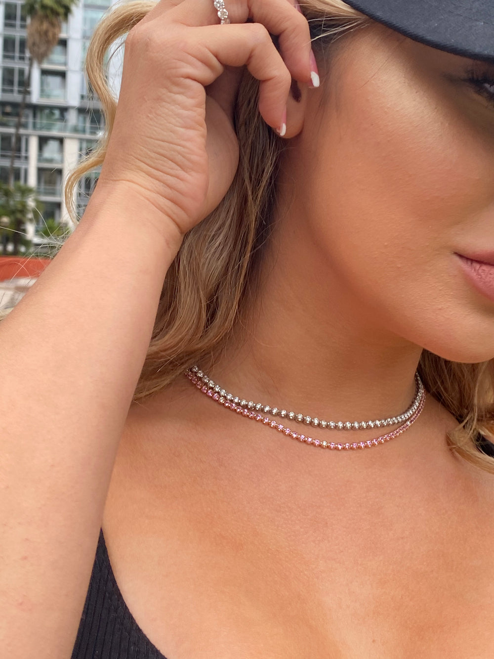adjustable-pink-sapphire-tennis-necklace-in-solid-gold-and-a-diamond-tennis-necklace-layered-together
