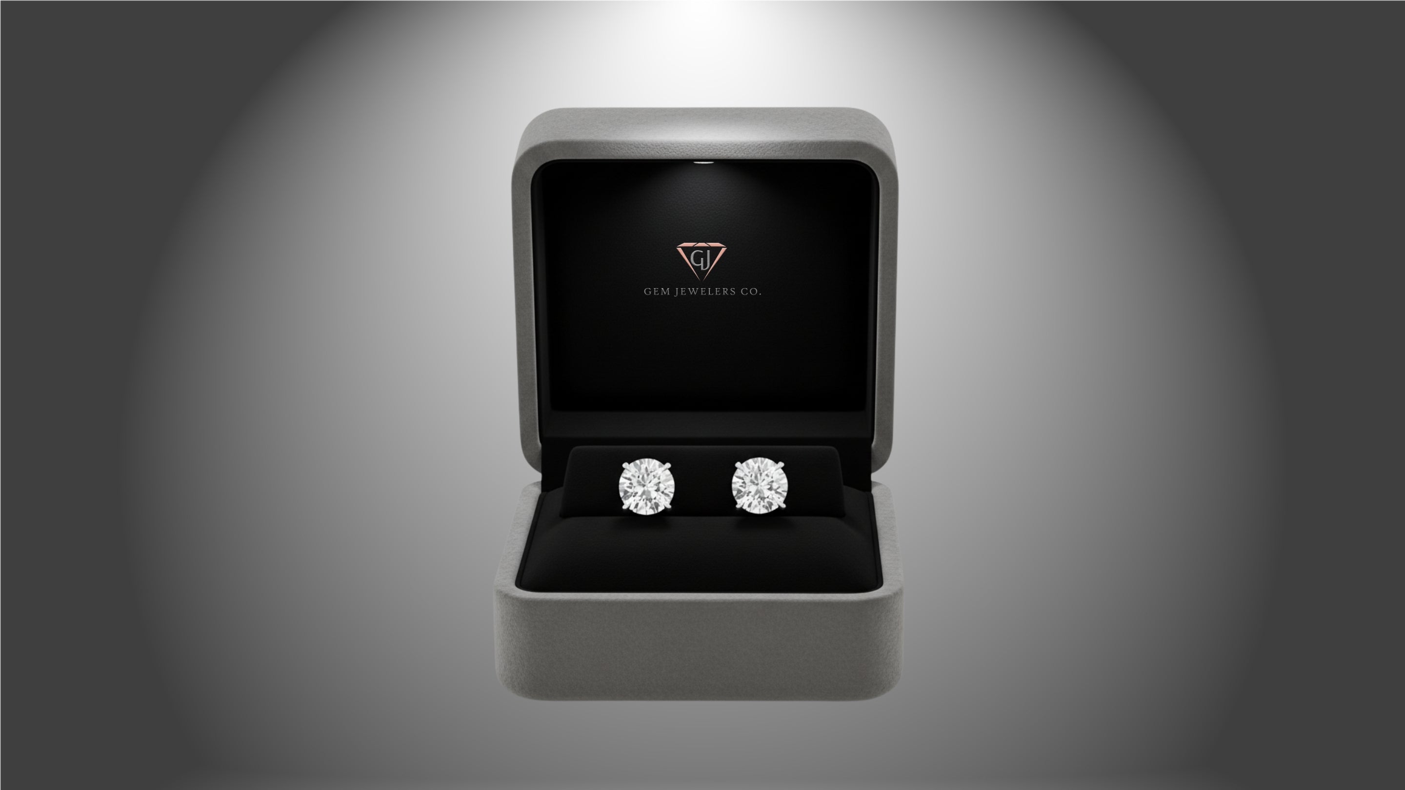 Diamond earrings in a jewelry box with a gray background