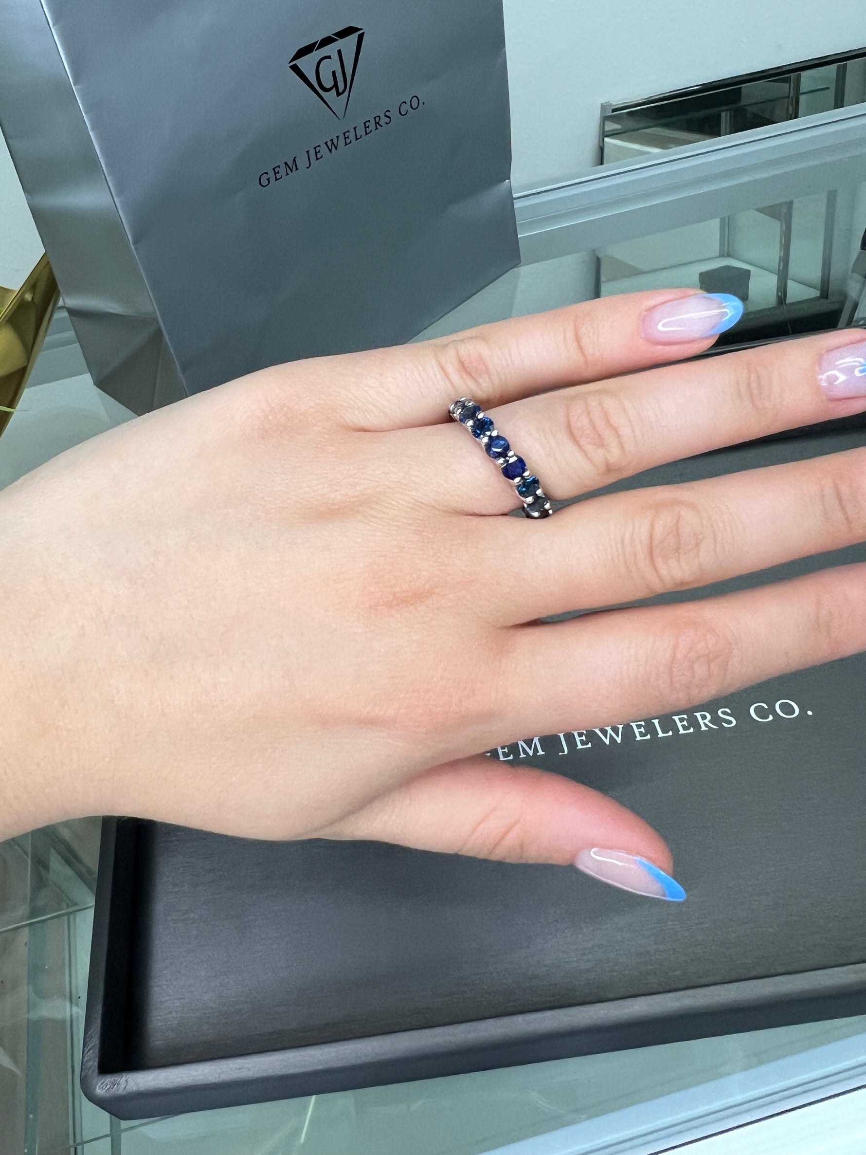 September - Round Cut Blue Sapphire Eternity Band - Gem Jewelers Co