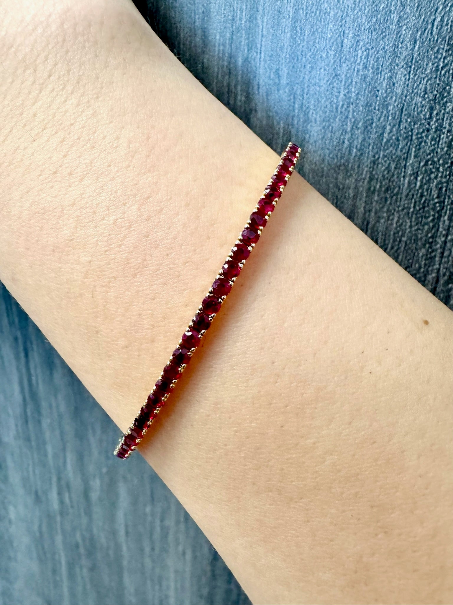 Rossa - Flexible Natural Red Ruby Bangle in 14K Lifestyle 1 - Gem Jewelers Co