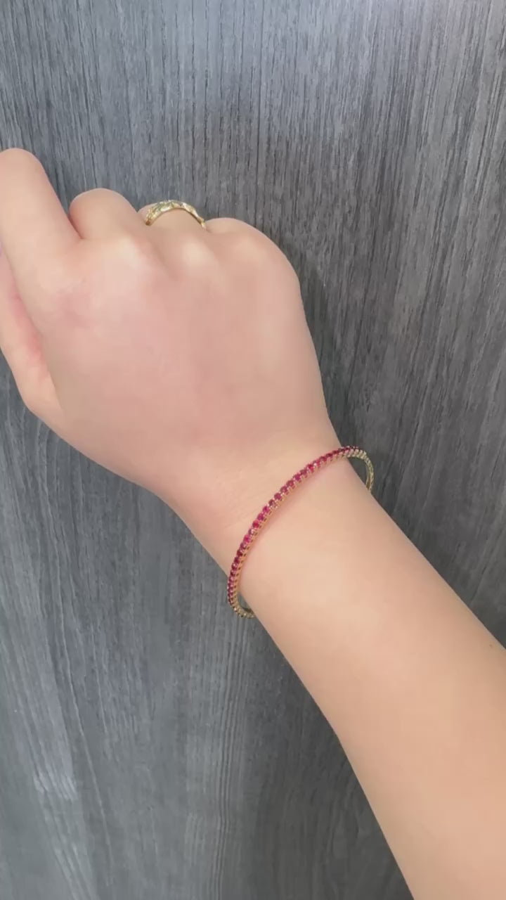 Rossa - Flexible Natural Red Ruby Bangle in 14K Solid Gold - Gem Jewelers Co Lifestyle Video 1