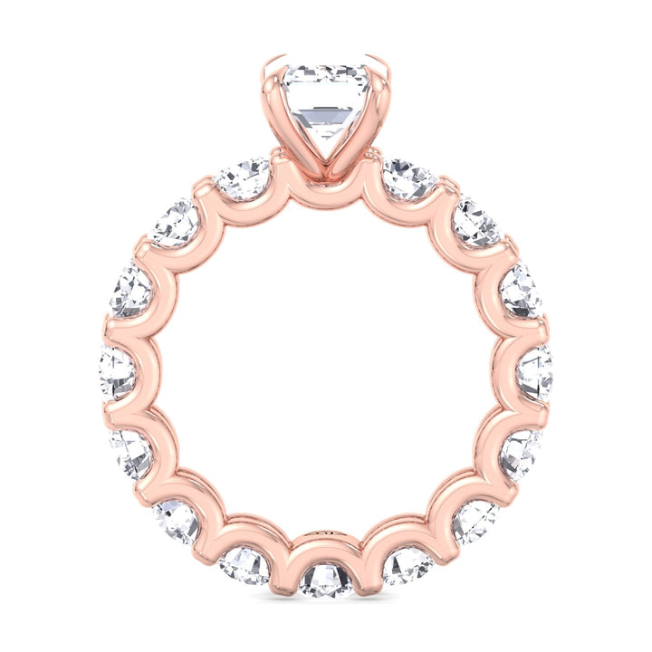  emerald-cut-diamond-eternity-ring-with-round-side-stones-in-rose-gold