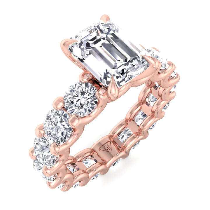 emerald-cut-diamond-eternity-ring-with-round-side-stones-in-solid-rose-gold