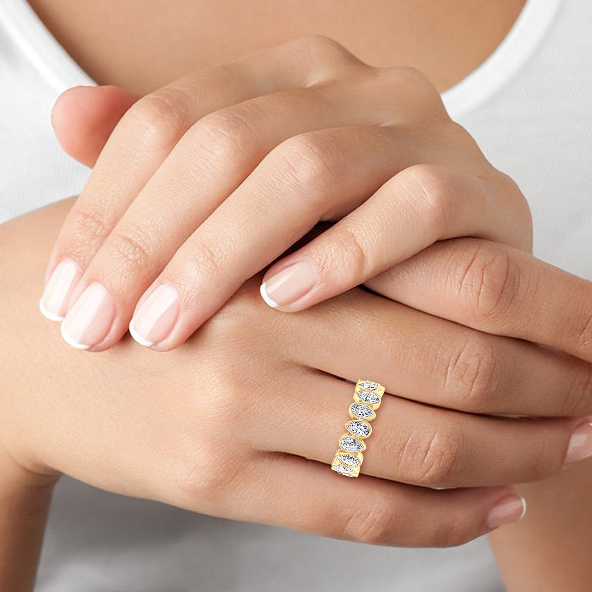 bezel-set-pear-shape-diamond-eternity-band-in-solid-yellow-gold