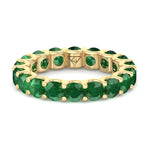 round-cut-green-emerald-eternity-band-in-solid-yellow-gold
