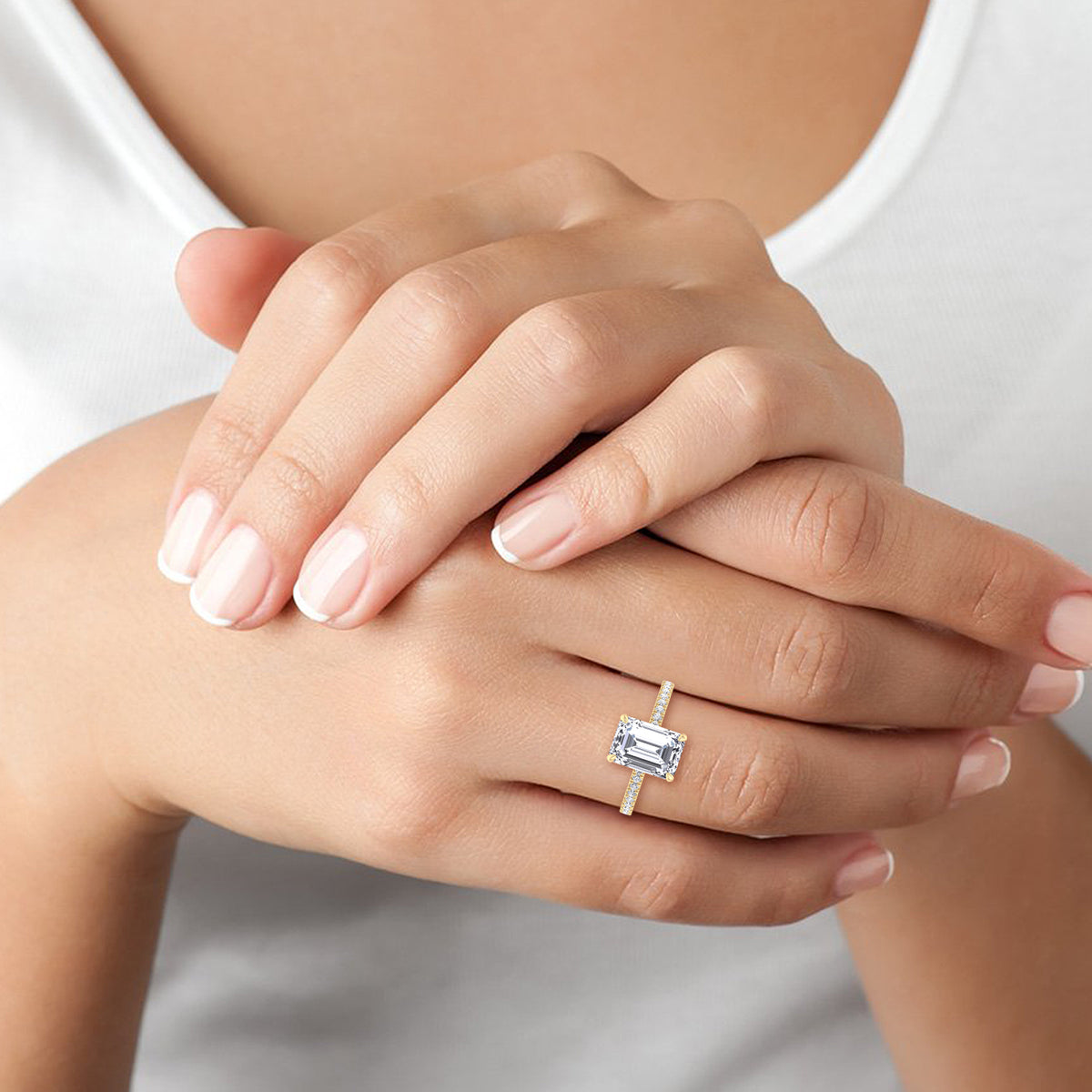 emerald-cut-diamond-engagement-ring-with-round-sidestones-in-yellow-gold