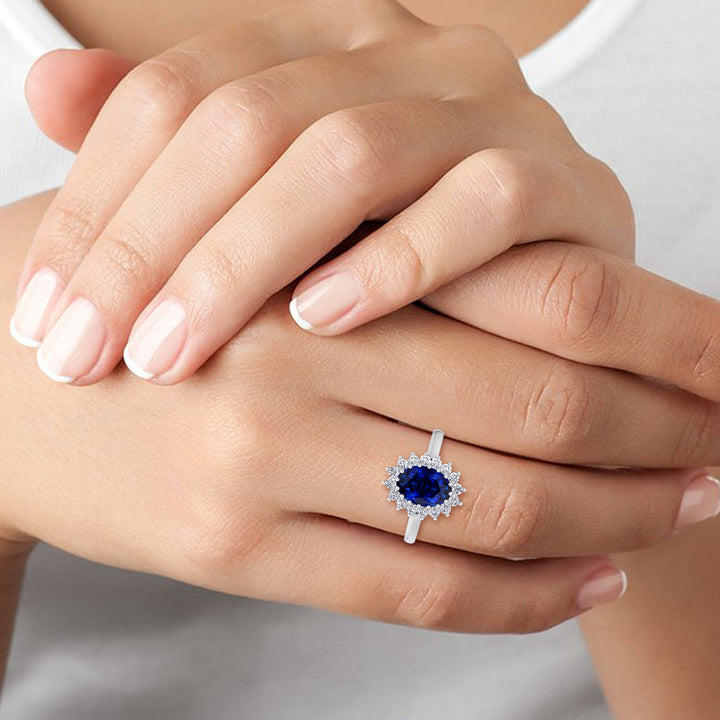 oval-cut-blue-sapphire-with-round-diamond-halo-engagement-ring-in-solid-white-gold