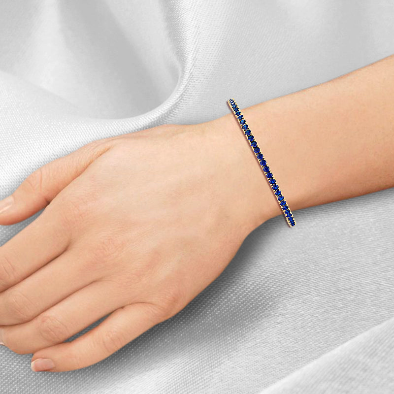 round-cut-blue-sapphire-tennis-bracelet-in-yellow-gold