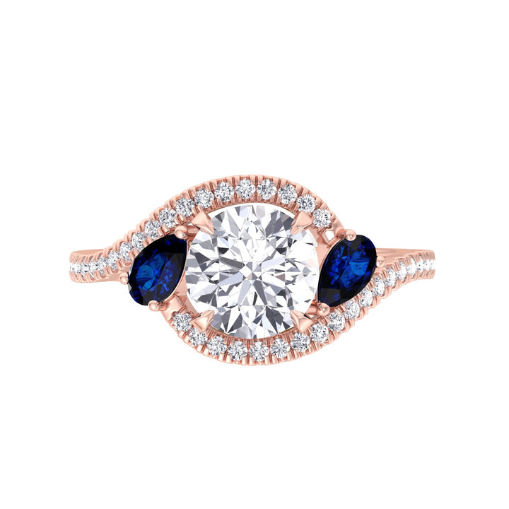 round-cut-diamond-engagement-ring-with-halo-and-blue-sapphire-pear-shape-sidestones-in-rose-gold