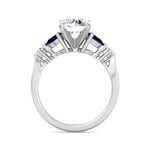 round-cut-diamond-engagement-ring-with-blue-sapphire-pear-shape-sidestones-in-solid-white-gold