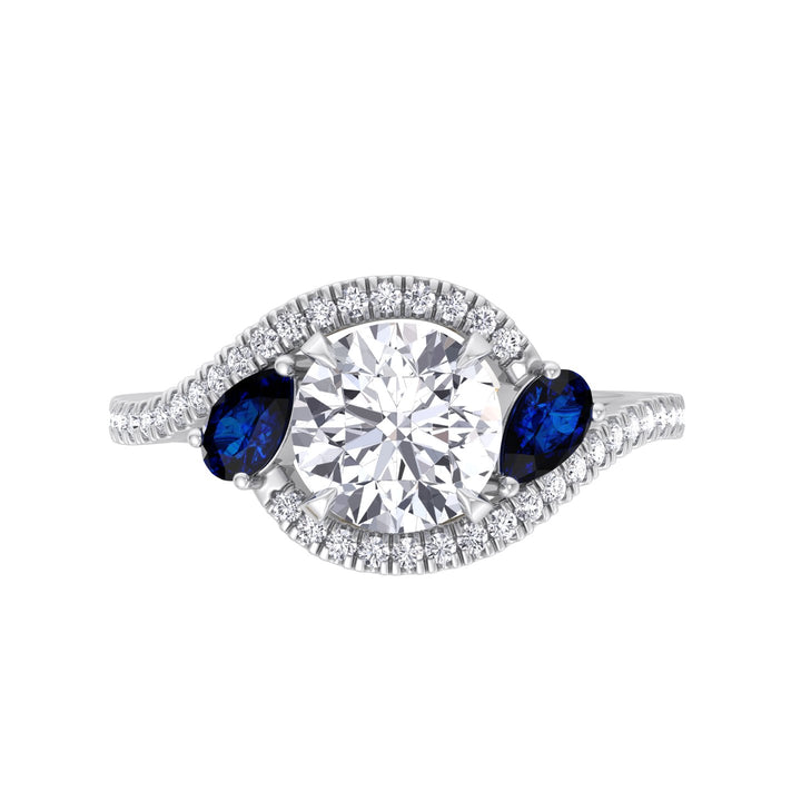 round-cut-diamond-engagement-ring-with-halo-and-blue-sapphire-pear-shape-sidestones-in-solid-white-gold