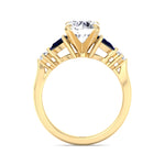 round-cut-diamond-engagement-ring-with-blue-sapphire-pear-shape-sidestones-in-yellow-gold