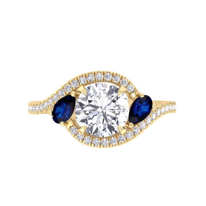 round-cut-diamond-engagement-ring-with-halo-blue-sapphire-pear-shape-sidestones-in-yellow-gol