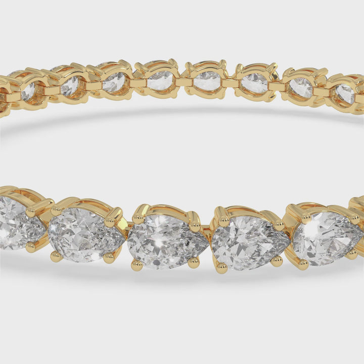 pear-shape-east-to-west-diamond-tennis-bracelet-yellow-gold
