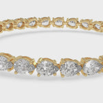 pear-shape-east-to-west-diamond-tennis-bracelet-yellow-gold