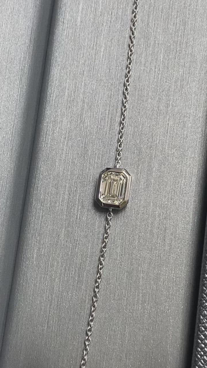 Bezel set natural diamond bracelet with emerald cut stones